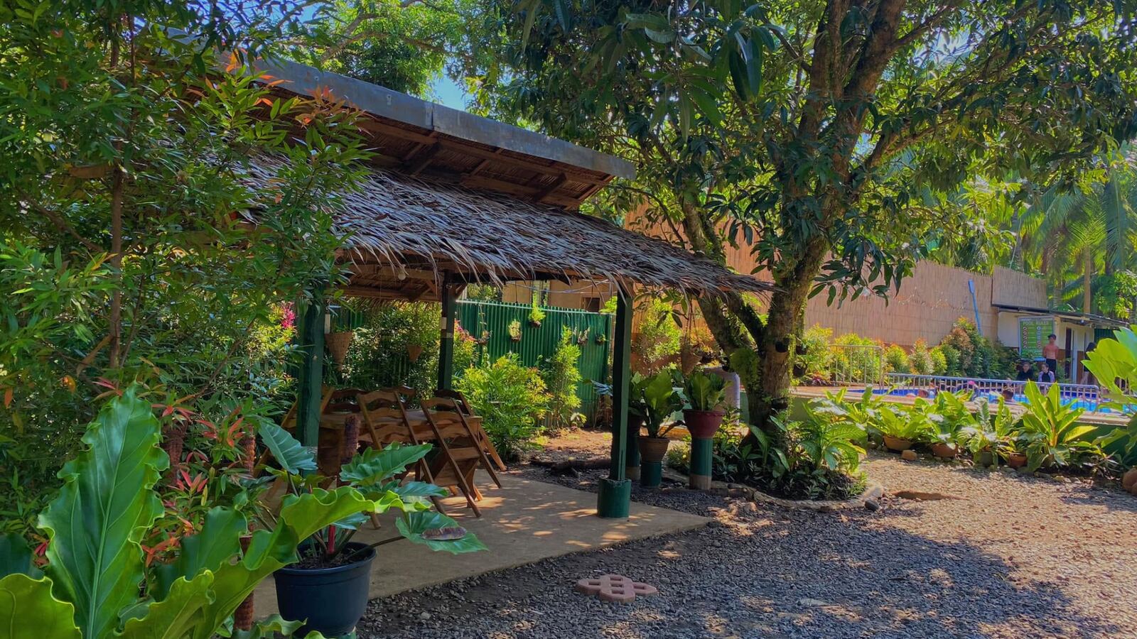 Thatched garden gazebo with the pool beyond