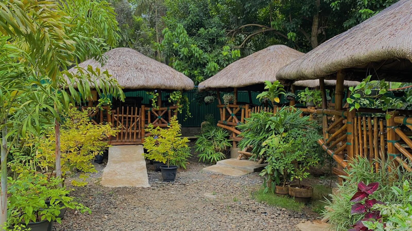 Row of nipa style bamboo huts in the garden